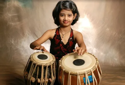 Young student performing tabla at Sai Kala Sangeet